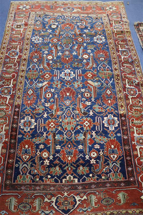 A Kazak style blue ground rug, woven with stylised flowerheads, 224cm x 135cm